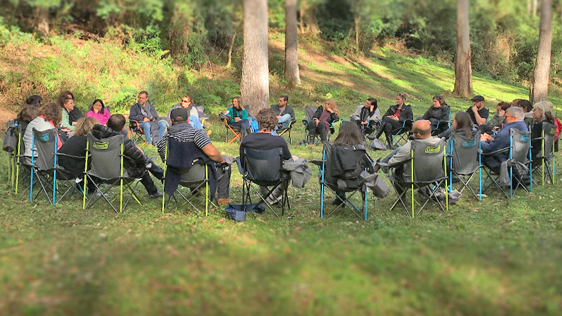 PAST RESIDENCIES Workshop people sitting under trees in a circle