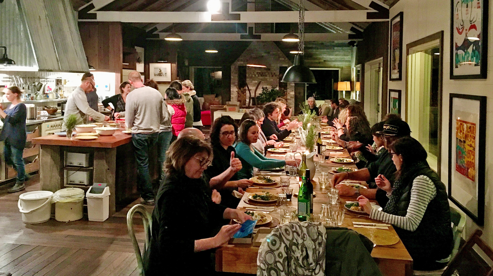 Internal view with people eating at the long table